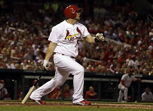 Matt Adams of the Cardinals watches his two-run home run sail out of the park during the sixth inning of Tuesday's game with the Reds in St. Louis.