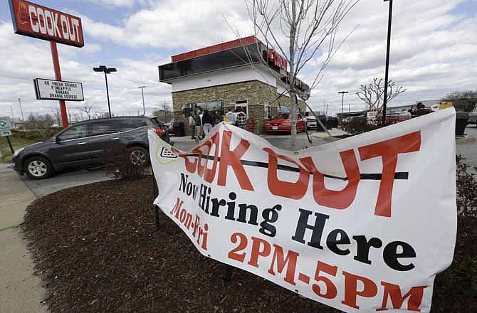 This Friday, March 29, 2013, photo, shows a help wanted sign in front of a restaurant in Richmond, Va. 