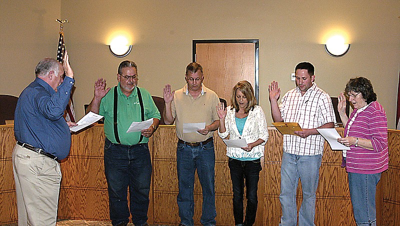 City officials elected on April 2 take the oath of office Monday, April 8, in the Council Chamber of the California City Hall. From left, City Clerk Brian Scrivner, left, administers the oath to Ward II Alderman Charles Roll, Mayor Norris Gerhart, City Collector Lesley Gerhart, Ward I Alderman Nathan Lewis and Ward III Alderwoman Carol Rackers.   
