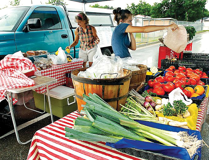 Local growers put their goods on display at the 2011 Fulton Farmer's Market. The 2013 market year will include a partial change of venue, moving to downtown Fulton on Saturday mornings.
