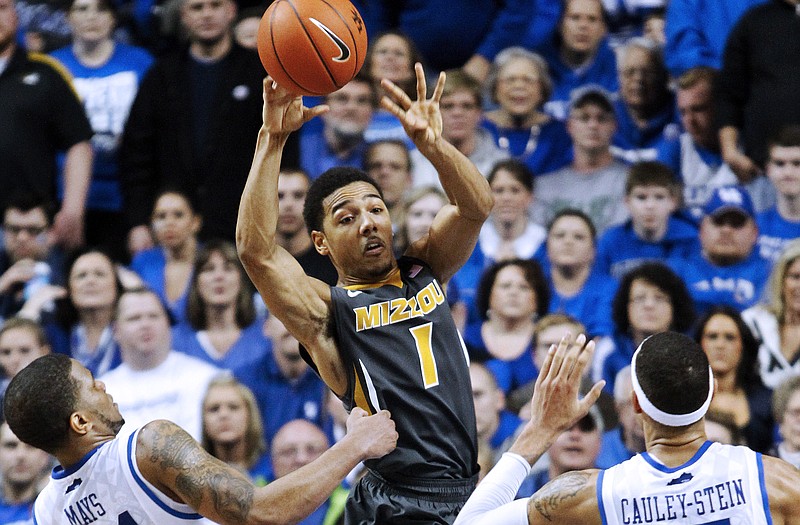 Missouri guard Phil Pressey passes between Kentucky teammates Julius Mays (34) and Willie Cauley-Stein during a game last season in Lexington, Ky.