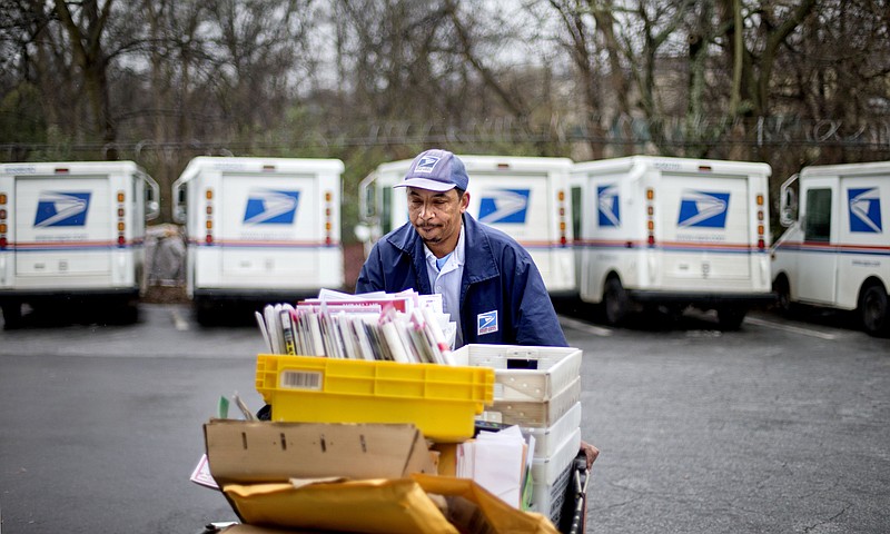 A postal worker is seen delivering mail for the U.S. Postal Service in this undated photo.
