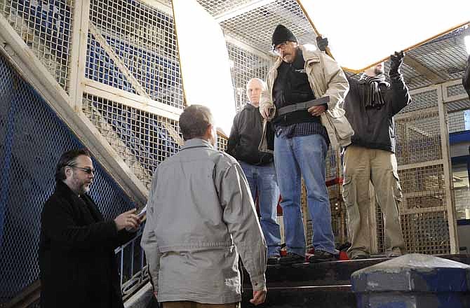 Director Andrew P. Jones, at left, gives actor John Zderko last minute direction, as cinematographer Warren Yeager, top of steps, explains the upcoming scene. Cast and crew have filmed scenes at the old Missouri State Penetentiary for an independent movie. Film makers are now seeking funds to help with post-production costs. 