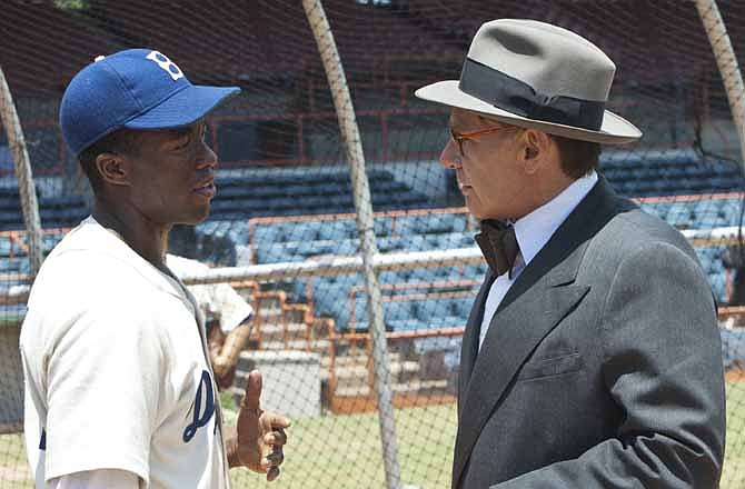 This film image released by Warner Bros. Pictures shows Chadwick Boseman as Jackie Robinson, left, and Harrison Ford as Branch Rickey in a scene from "42." 