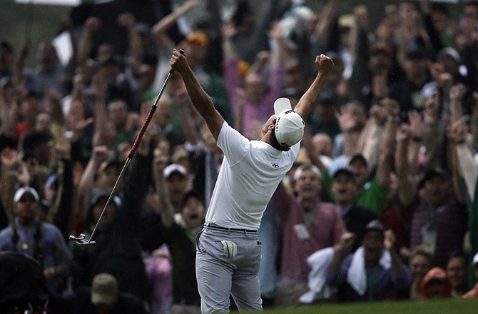 Adam Scott celebrates after making a birdie putt on the second playoff hole to win the Masters on Sunday in Augusta, Ga.