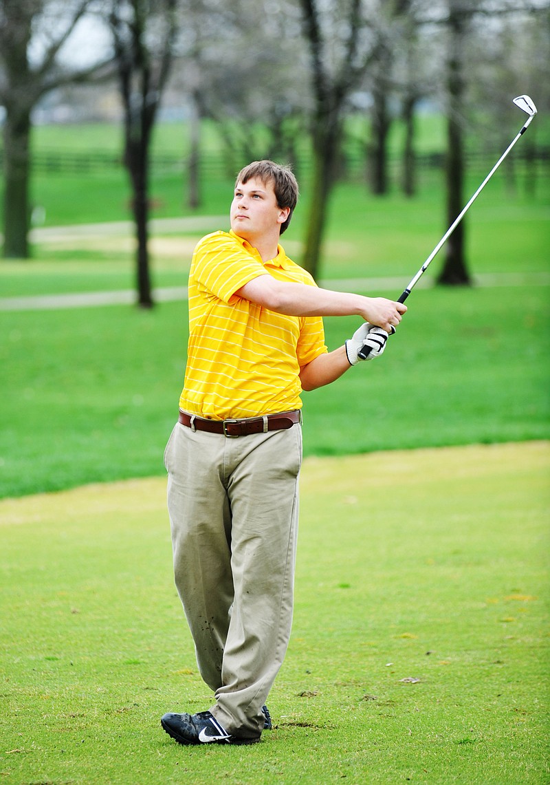 Helias senior Brandon Tomlinson watches the flight of his drive during the Helias Invitational on Monday at Meadow Lake Acres Country Club.