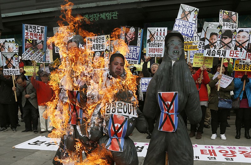 South Korean protesters burn effigies of North Korean leader Kim Jong Un, and late leaders Kim Jong Il and Kim Il Sung at an anti-North Korea protest Monday, on the birthday of Kim Il Sung in Seoul, South Korea. 