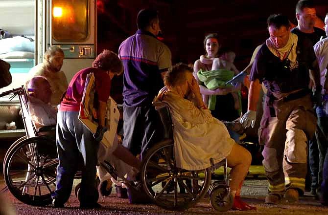 Emergency workers evacuate elderly from a damaged nursing home following an explosion at a fertilizer plant Wednesday, April 17, 2013, in West, Texas. An explosion at a fertilizer plant near Waco caused numerous injuries and sent flames shooting high into the night sky on Wednesday. 