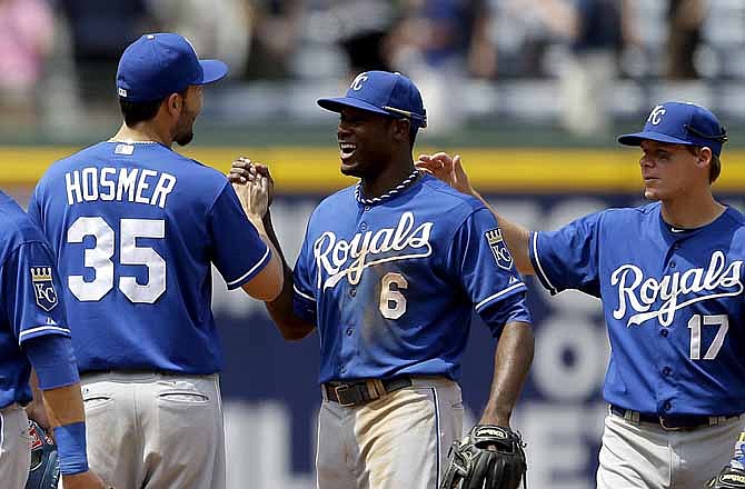Kansas City Royals' Lorenzo Cain, center, high-fives teammate Eric Hosmer, left, after the Royals defeated the Atlanta Braves 1-0 in a baseball game, Wednesday, April 17, 2013, in Atlanta.