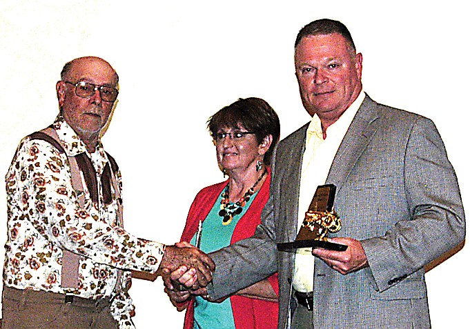 At the annual SWCD awards banquet, Carl Allee, left, presents Joyce and David Shaul with the 2012 Cooperator of the Year Award. Allee is Chairman of the SWCD Board of Supervisors. The Shauls own and operate a farm northeast of Jamestown.    