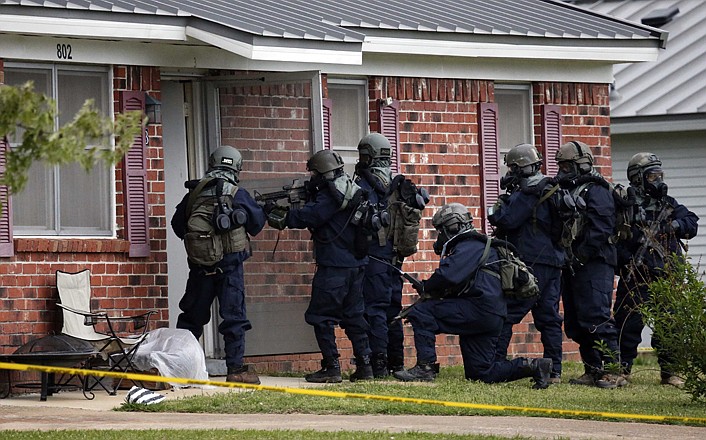 Armed federal agents wearing hazardous material suits and breathing apparatus Thursday entered the West Hills Subdivision home of Paul Kevin Curtis in Corinth, Miss. Law enforcement officials blocked off the dwelling after taking Curtis into custody under the suspicion of sending letters covered in ricin to the U.S. President Barack Obama and U.S. Sen. Roger Wicker, R-Miss.