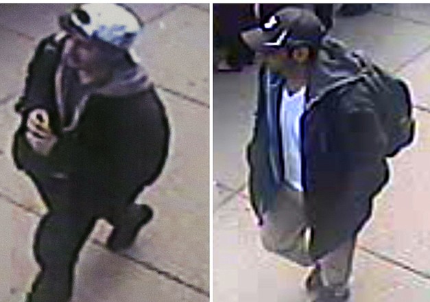 This combination of images released by the FBI on Thursday shows images taken from surveillance video of men the FBI are calling suspect number 2, left, in white cap, and suspect number 1, right, in black cap, as they walk near each other through the crowd before the explosions at the Boston Marathon on Monday.