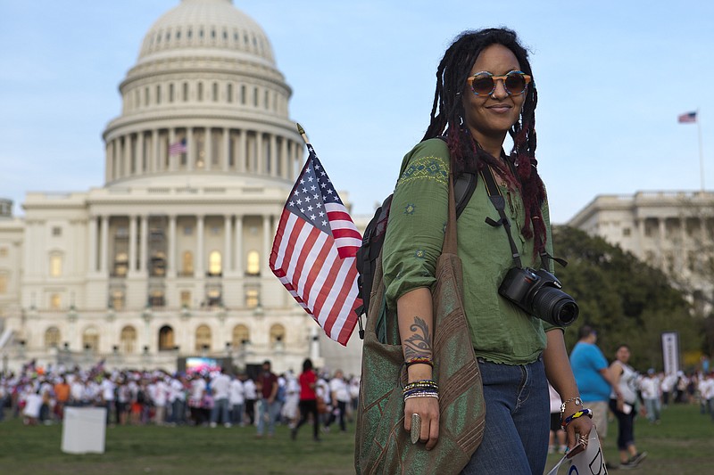 Ajna Opiotennione, 28, of Washington, who emigrated from Ethiopia, poses for a portrait after attending the "Rally for Citizenship," a rally in support of immigration reform, on Capitol Hill in Washington, on April 10. A bipartisan group unveiled an immigration bill on Thursday that includes a pathway to citizenship for the nation's 11 million immigrants with illegal status. 