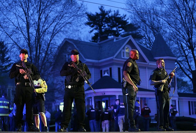 Police officers guard the entrance to Franklin street where the second suspect in the Boston Marathon bombings was hiding Friday in Watertown, Mass. Gunfire erupted Friday night amid the manhunt for the surviving suspect in the Boston Marathon bombing, and police captured the suspect after about a hour.