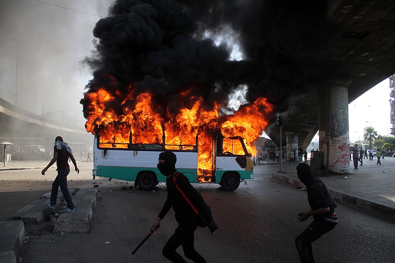 Egyptian protesters clash near a bus Friday belonging to Muslim Brotherhood supporters after it was reportedly burned by antigovernment protesters in Cairo.