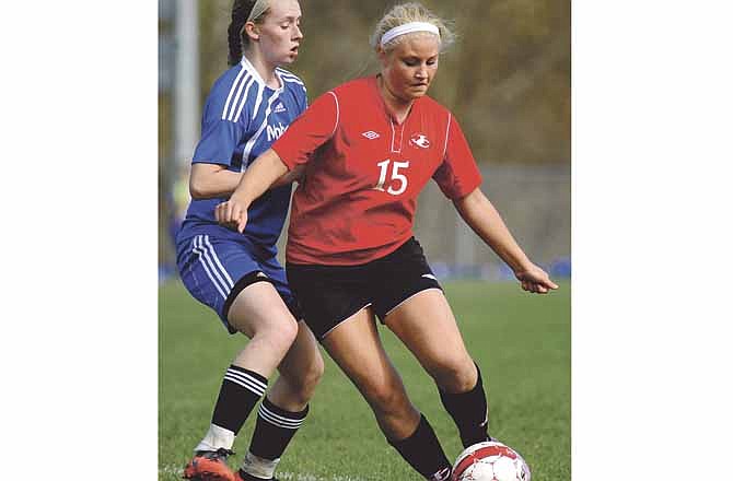 Jefferson City midfielder Megan Martens dribbles past Moberly defender Mackenzie Cullifer during Capital City Invitational action Saturday at 179 Soccer Park in Jefferson City.