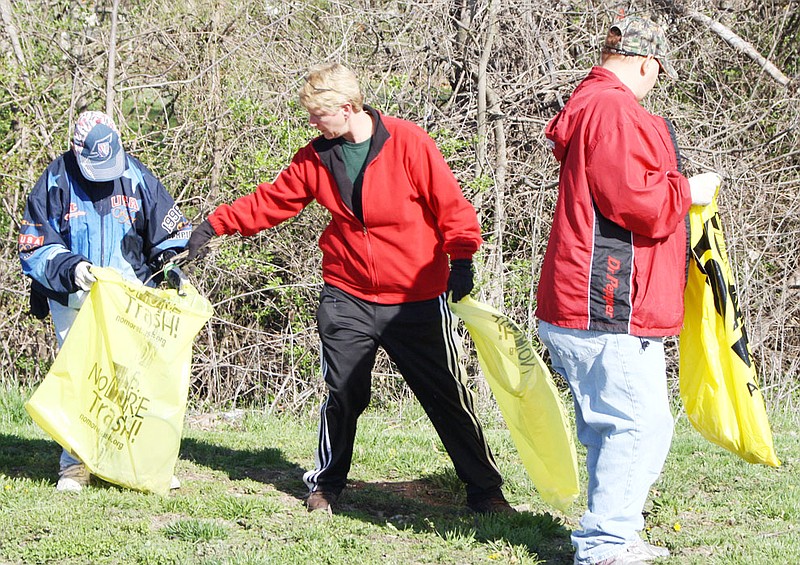 Volunteering to clean up trash during Clean Sweep Saturday at the intersection of East 1st and Ravine streets in Fulton are, from left, Tim Eastwood of Fulton, Jean Mackey of Auxvasse, and Billy Wallace of Fulton.
