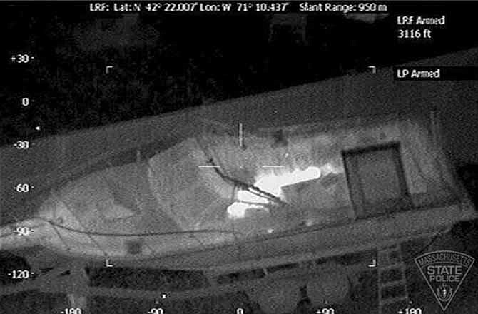 This Friday, April 19, 2013 image made available by the Massachusetts State Police shows 19-year-old Boston Marathon bombing suspect, Dzhokhar Tsarnaev, hiding inside a boat during a search for him in Watertown, Mass. He was pulled, wounded and bloody, from the boat parked in the backyard of a home in the Greater Boston area. (via AP)