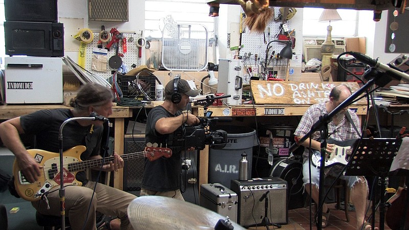 Jefferson city native Doug Hawes-Davis, center, films The Gourds guitarist Kevin Russell as he rehearses with bassist Jimmy Smith in their Austin, Texas, rehearsal space on Aug. 31, 2011. 