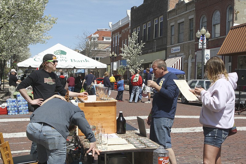 Visitors taste samples from the Broadway Brewery in Columbia during the first Morels and Microbrews Festival in downtown Fulton on Saturday. The event, a fundraiser for the Brick District Association, drew more than 200 people to Court Street to taste microbrews and morel mushrooms.