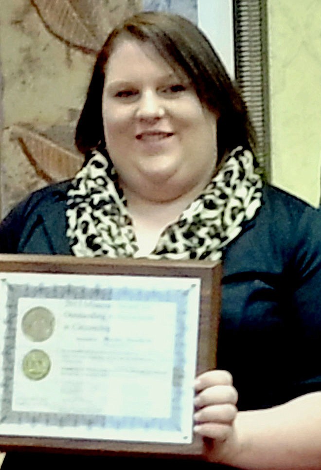 Hayley Munford, a New Bloomfield High School senior, holds a statewide  Outstanding Achievement in Citizenship Award she received Tuesday in Jefferson City.