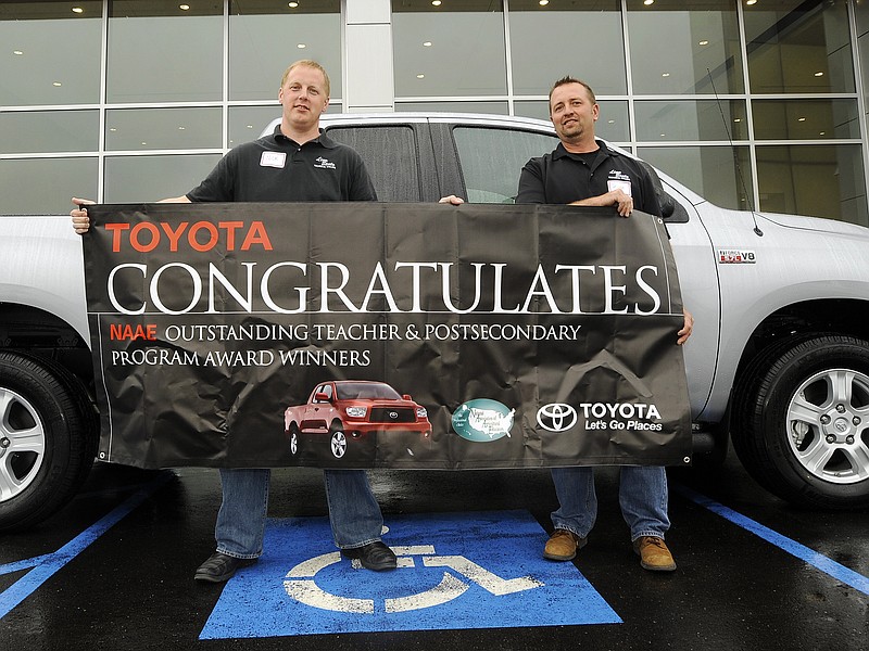 Linn State Technical College agriculture professors Nick Rackers, left, and Ryan Klatt stand in front of a new 2013 Toyota Tundra pickup truck awarded to them during Tuesday's grand opening at Riley Toyota.