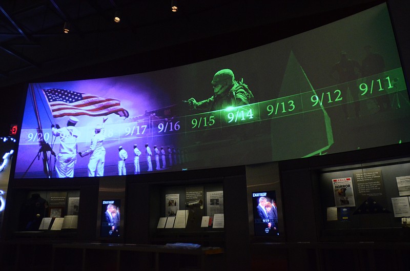 A large screen displays images and video of the events and days that followed the 9/11 terrorist attacks as part of an exhibit in the museum area at the George W. Bush Presidential Library and Museum in Dallas.  The museum uses everything from news clips to interactive screens to artifacts to tell the story of Bush's eight years in office.