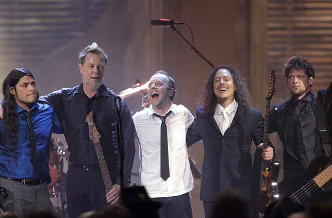 This April 4, 2009 file photo shows the band Metallica, from left, Robert Trujillo, James Hetfield, Lars Ulrich, Kirk Hammett and Jason Newsted, after being inducted into the Rock and Roll Hall of Fame at the 2009 Rock and Roll Hall of Fame Induction Ceremony in Cleveland. 