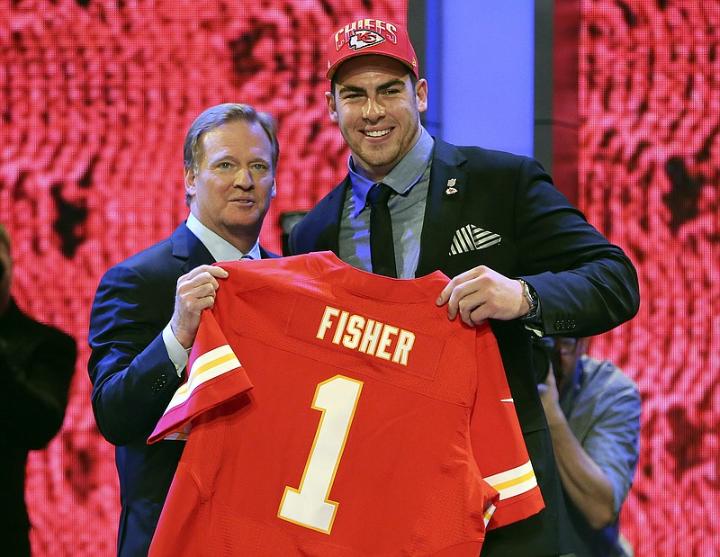 Eric Fisher of Central Michigan stands with NFL commissioner Roger Goodell after being selected first overall in the NFL draft by the Chiefs in New York.
