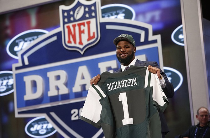 Sheldon Richardson of Missouri holds up a team jersey Thursday night after being selected 13th overall by the New York Jets in the first round of the NFL draft in New York.