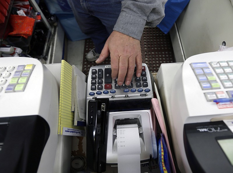 Jack Yonally rings out a customer at Lodge's store in Albany, N.Y. The Commerce Department issues its first estimate of how fast the U.S. economy grew Friday in the January-March quarter.