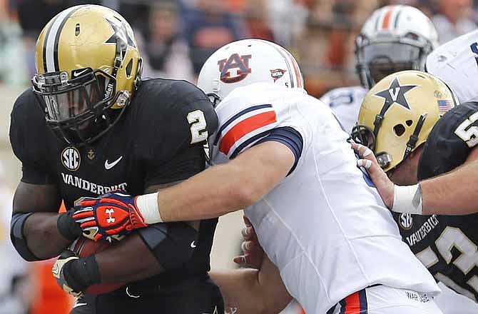 In this Oct. 20, 2012, file photo, Vanderbilt's Zac Stacy, left, scores a touchdown against Auburn in the third quarter of an NCAA college football game in Nashville, Tenn. 