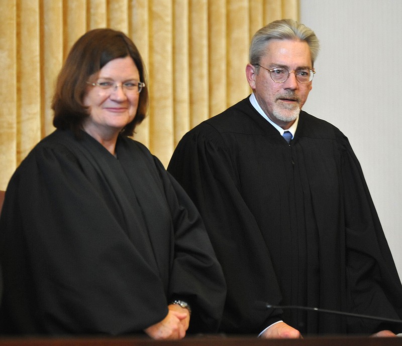 The Honorable Paul C. Wilson takes his place on the bench, next to Judge Laura Denvir Stith, after being sworn in as the newest member of the Missouri Supreme Court. 