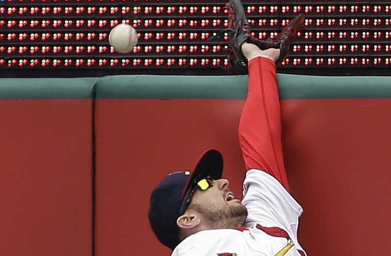 Cardinals right fielder Shane Robinson cannot reach a ball hit for a solo home run by Garrett Jones of the Pirates during the seventh inning of Sunday afternoon's game at Busch Stadium.