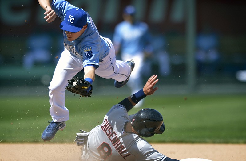 Royals second baseman Chris Getz leaps over Lonnie Chisenhall of the Indians after recording an out during the seventh inning of Sunday afternoon's game at Kauffman Stadium.