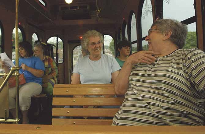 Nancy Gilliam, left, talks with Anna Billington aboard the new Joplin Sunshine Lamp Trolley on July 30, 2007. Joplin transit operates under a demand - response system, something Jefferson City is looking into.