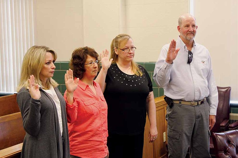 From left: Lisa Dresner of Boone County, Linda Willenburg of Fulton, Mary Beth Stephens of Hatton and Trent Willenburg of Fulton are sworn in as Court Appointed Special Advocates for children Tuesday. Stephens and the Willenburgs are the first class from Callaway County to enter the program, which matches volunteers with foster children to have an advocate during court proceedings.