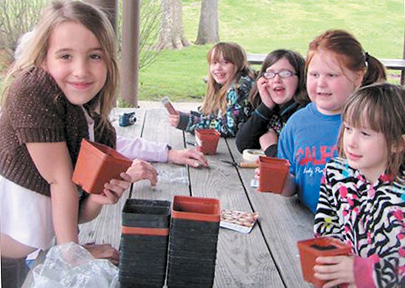 The Twin City Garden Club, California, teamed up with local Brownie Troop members, above, to celebrate Earth Day at Proctor Park Monday,