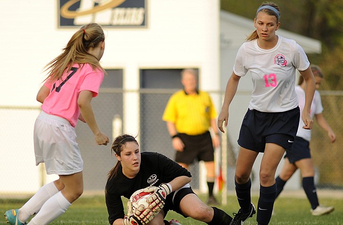 Jefferson City goalkeeper Becca Sturgess leaves her line and collects a through ball before Helias midfielder Kaysie Scheuler can get to the ball.