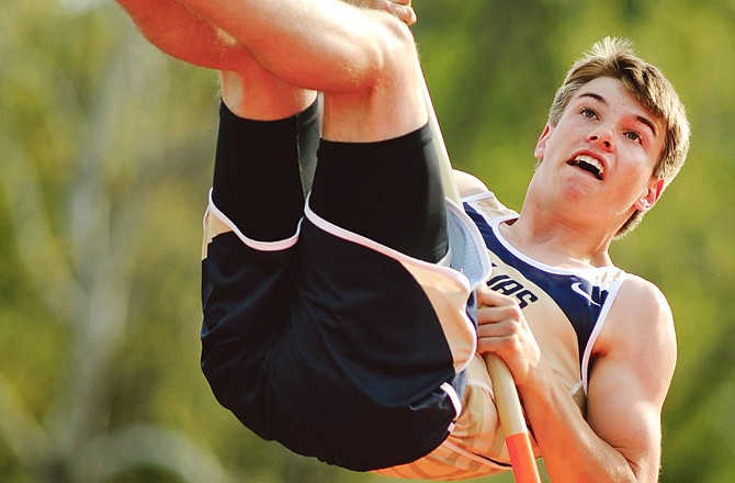 Helias pole vaulter Tyler Schrimpf attempts to cross the bar during a triangular Wednesday at Adkins Stadium.