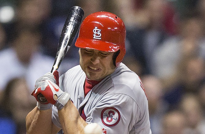 Matt Holliday of the Cardinals is hit with a pitch in the third inning of Thursday night's game against the Brewers in Milwaukee.