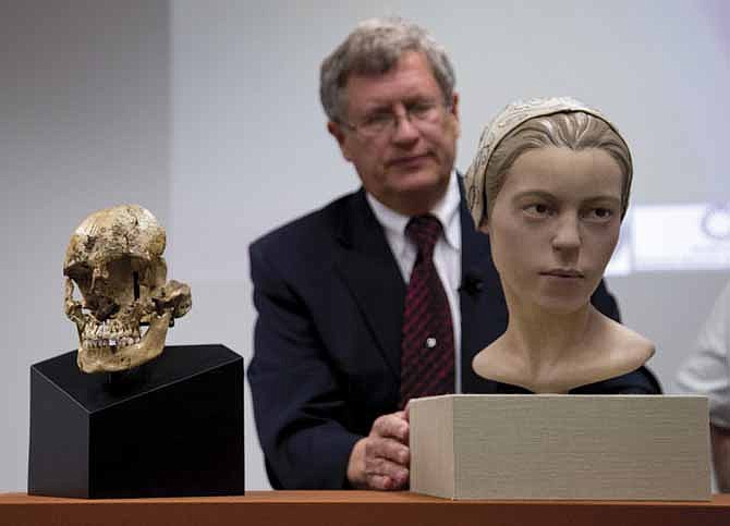 Doug Owsley, division head for Physical Anthropology at the Smithsonian's National Museum of Natural History, displays the skull and facial reconstruction of  "Jane of Jamestown" during a news conference at the museum in Washington.