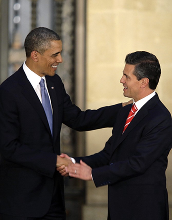President Barack Obama and Mexico's President Enrique Pena Nieto shake hands Thursday after offering a joint news conference in Mexico City, Mexico. Seeking to put a new spin on a long-standing partnership, Obama is promoting jobs and trade - not drug wars or border security - as the driving force behind the U.S.-Mexico relationship.