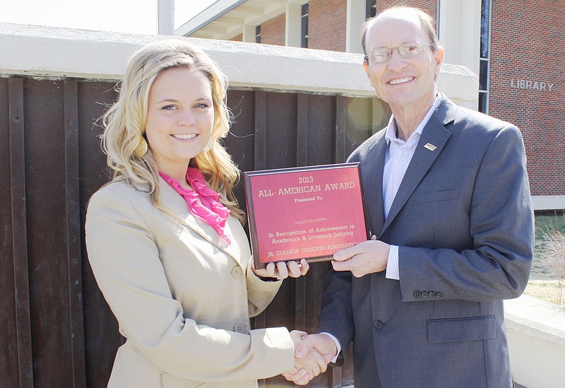 Montgomery receiving the All-American Award from Dr. Jeff Hale, president of NEO. 