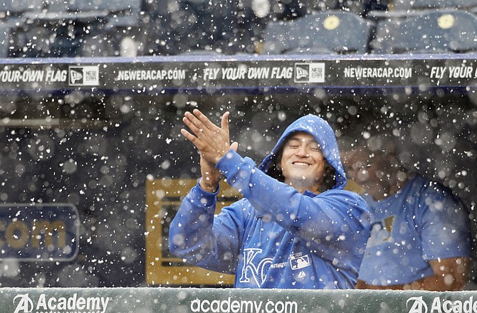 Royals pitcher Luis Mendoza rubs his hands as snow falls after Thursday afternoon's game against the Rays was stopped in the fourth inning at Kauffman Stadium.