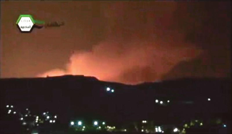 Smoke and fire fill the the skyline over Damascus, Syria, early Sunday, after an Israeli warplanes struck areas in and around the Syrian capital, setting off a series of explosions as they targeted a shipment of highly accurate, Iranian-made guided missiles believed to be on their way to Lebanon's Hezbollah militant group.