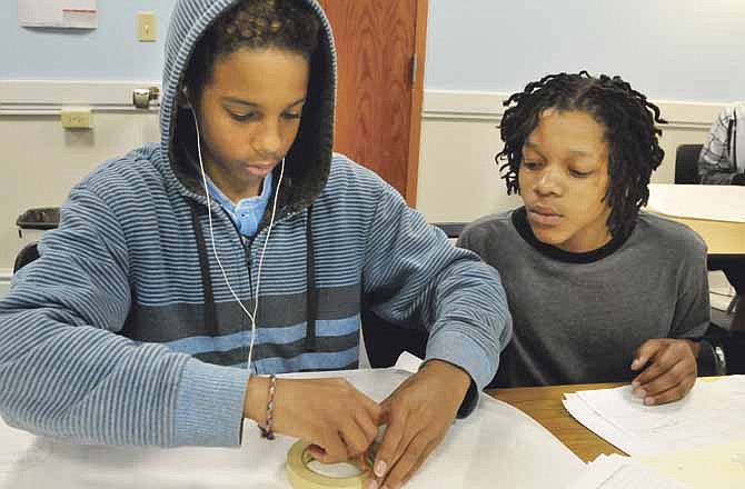 Shyheim Knight, left, and Willie Knight, both sophomores at Jefferson City Academic Center, work on a biology project in Brie Roberts' class.