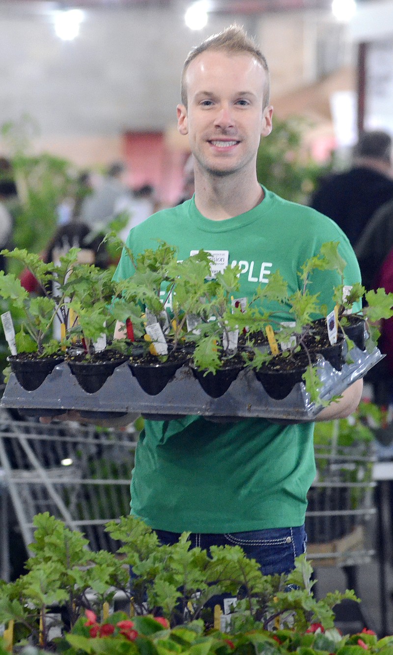 Jake Seifert works at the Master Gardener's Plant Sale at the fairgrounds on Saturday.