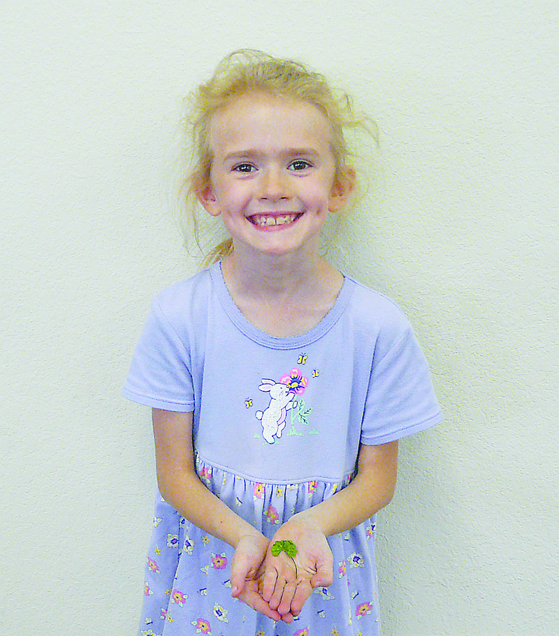 Samantha Davis, 7, daughter of Scott  Davis, holds a five leaf clover. She found the clover playing outside her home. Samantha feels pretty lucky at finding clovers.  Last year she found 20-25  four leaf clovers, however, this is her very first five leaf.