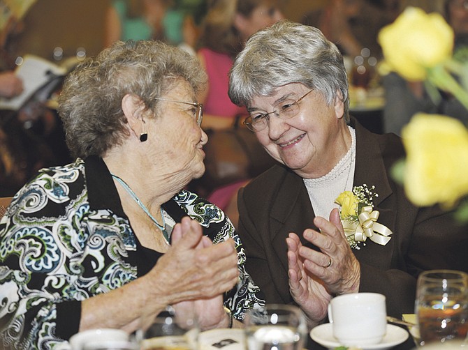 Sr. Evelyn Peterman, right, shares a moment with longtime friend Alma Sandbothe. They have been in the same spiritual group since that 1974. 